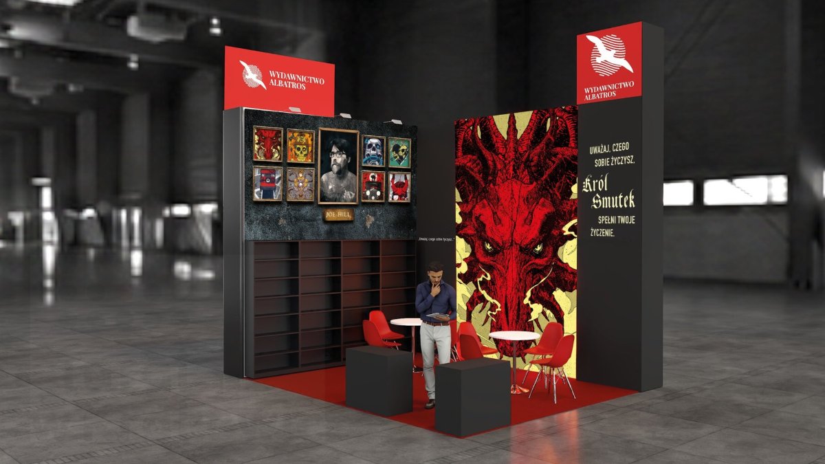 The smaller stand dedicated to Joe Hill, with framed cover illustrations and oversized red dragon visual